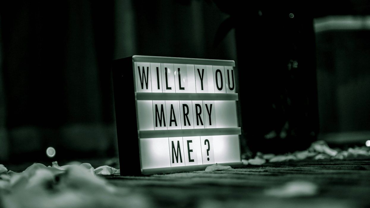 Black and white photo of a sign asking "Will You Marry Me?"