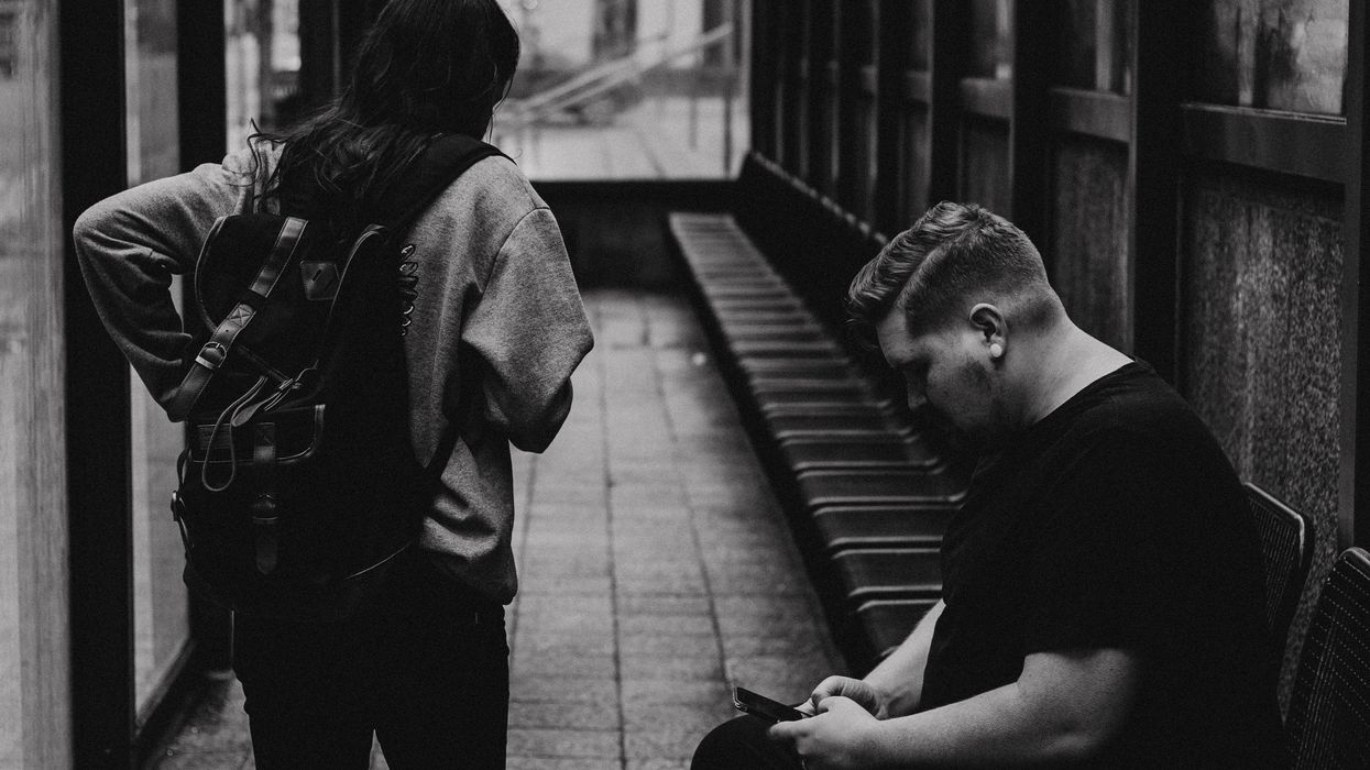 Black and white photo of two people on a platform