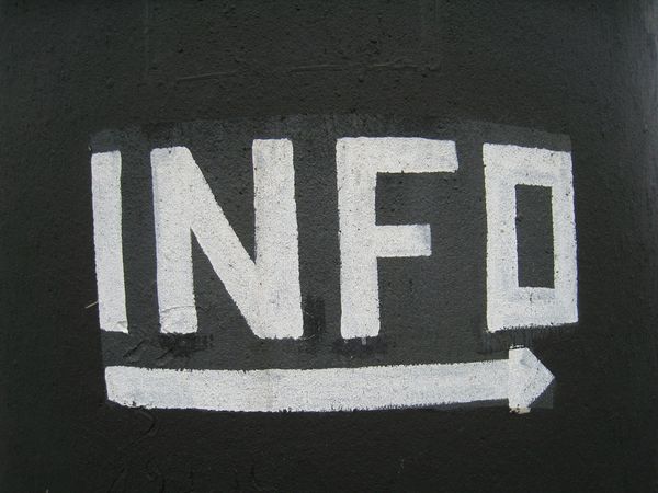 Black and white photo saying the abbreviation "info" in caps, with an arrow pointing to the left underneath