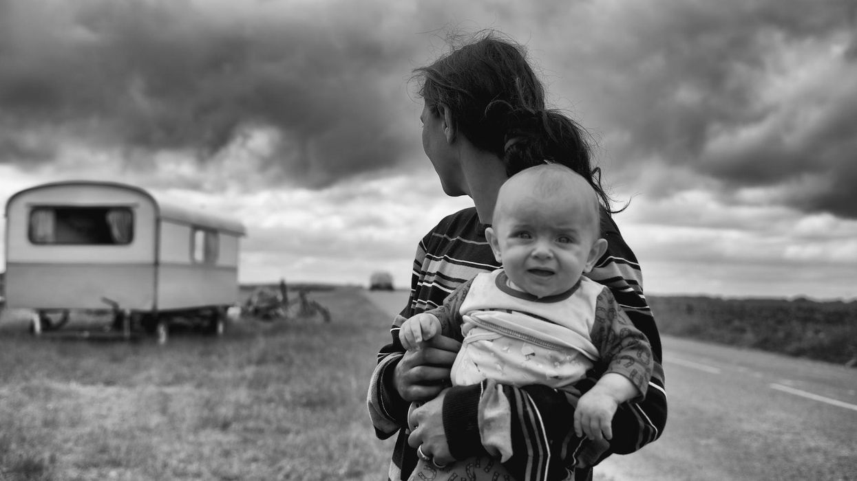 Black and white photo with a mom holding a distressed baby