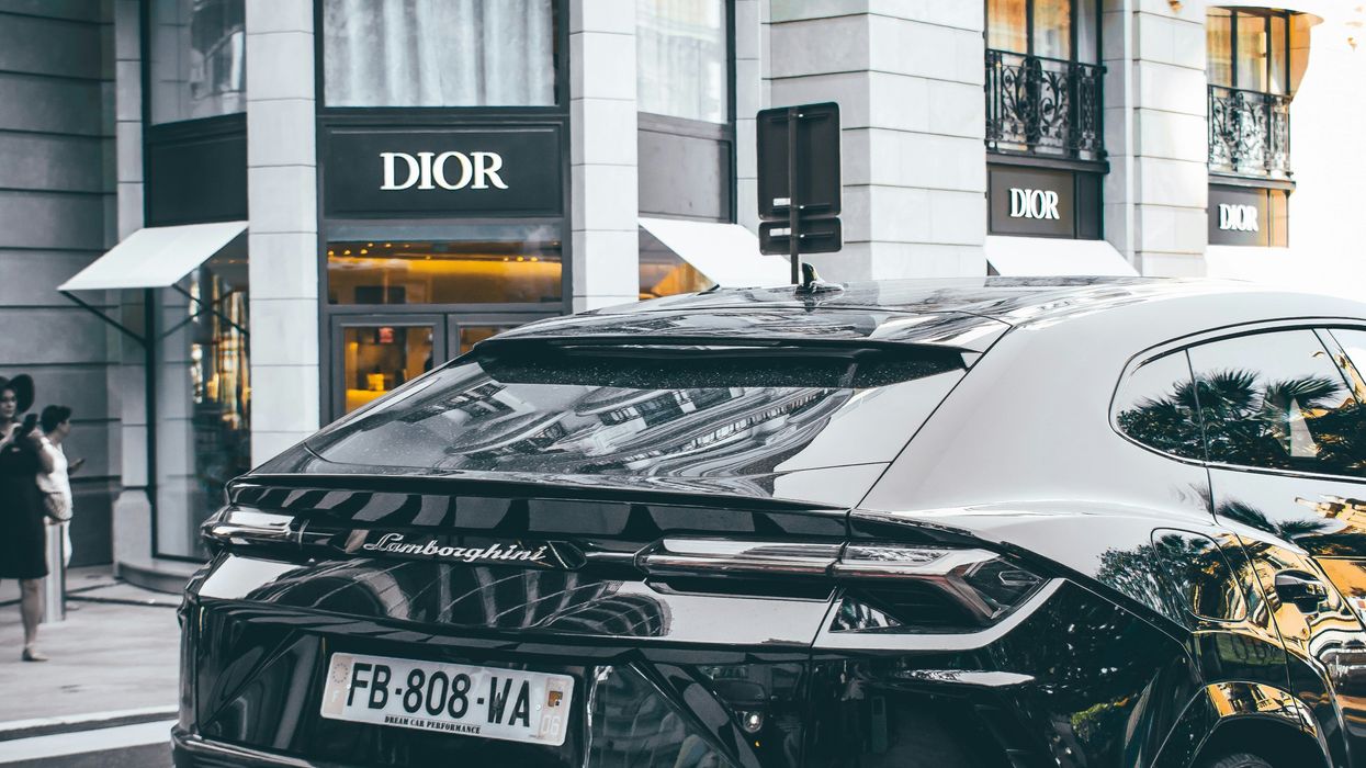 black Lamborghini parked in front of a boutique