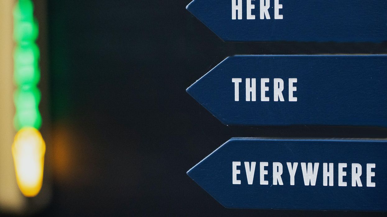 Blue pointed signs that read, "Here, There, Everywhere"