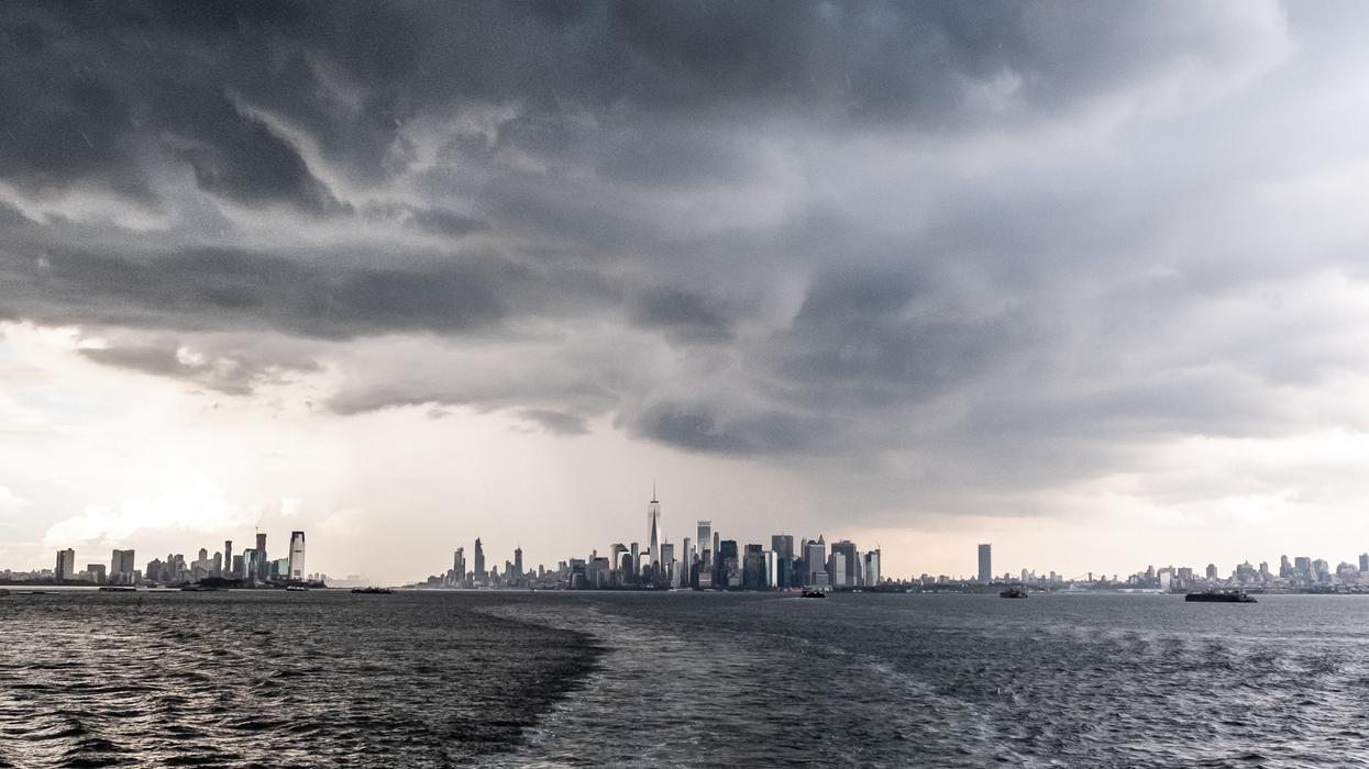 body of water under gray clouds