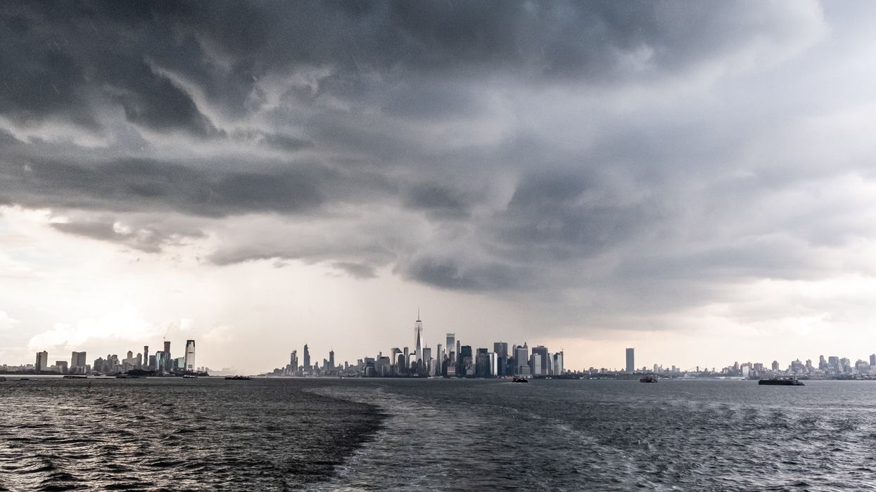 body of water under gray clouds