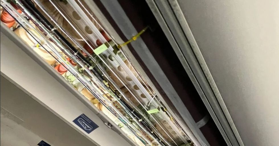 Boeing 757's Ceiling panel exposed wiring and cables visible from a similar incident on April 14th.
