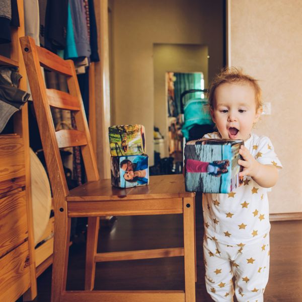 boy in white and blue pajama set holding white and red plastic cup