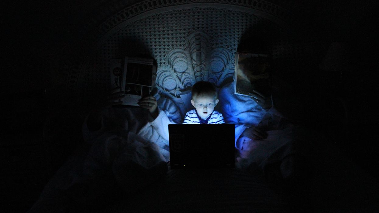 boy playing at laptop inside room