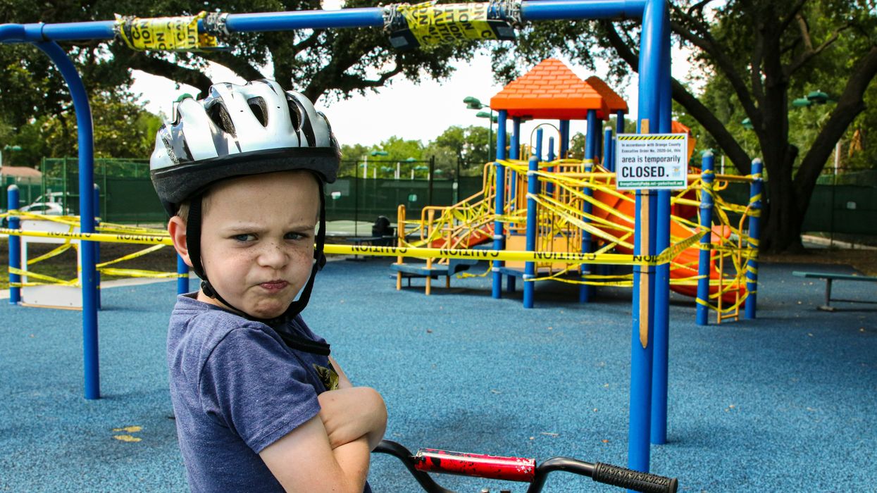 boy riding red bicycle