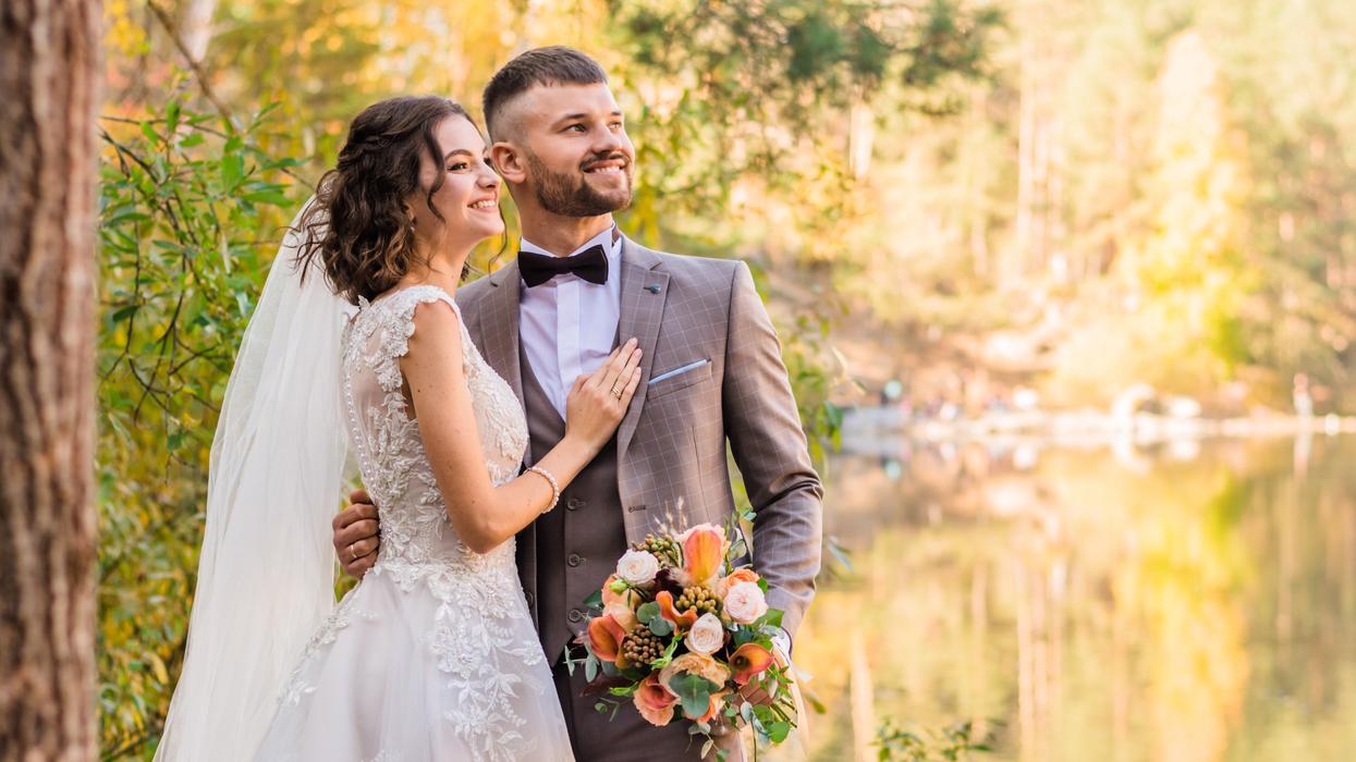 Bride and groom by a lake