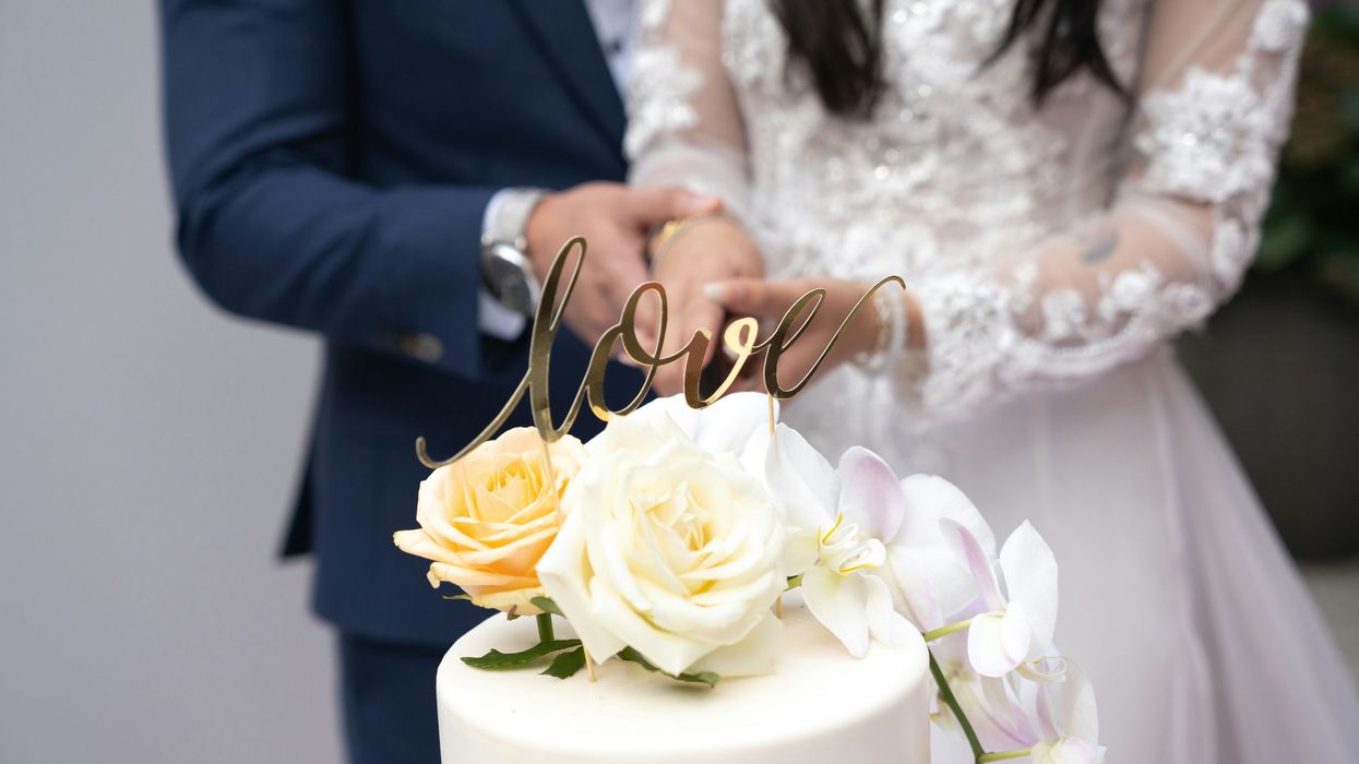 bride and groom cutting wedding cake