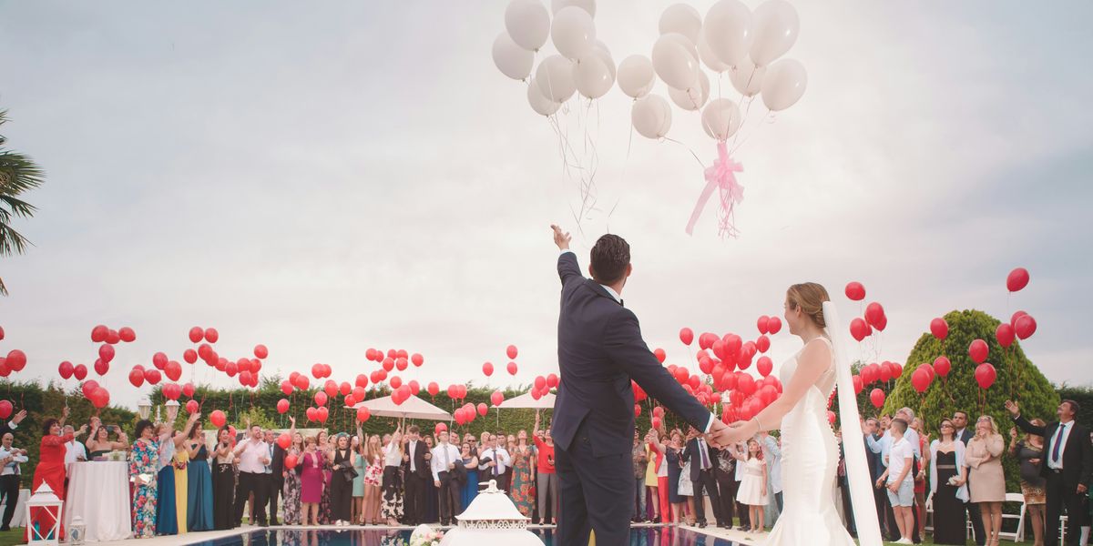 Bride and groom releasing balloons at a wedding