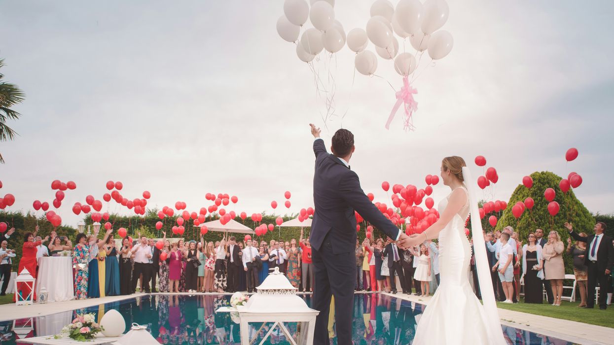 Bride and groom releasing balloons at a wedding