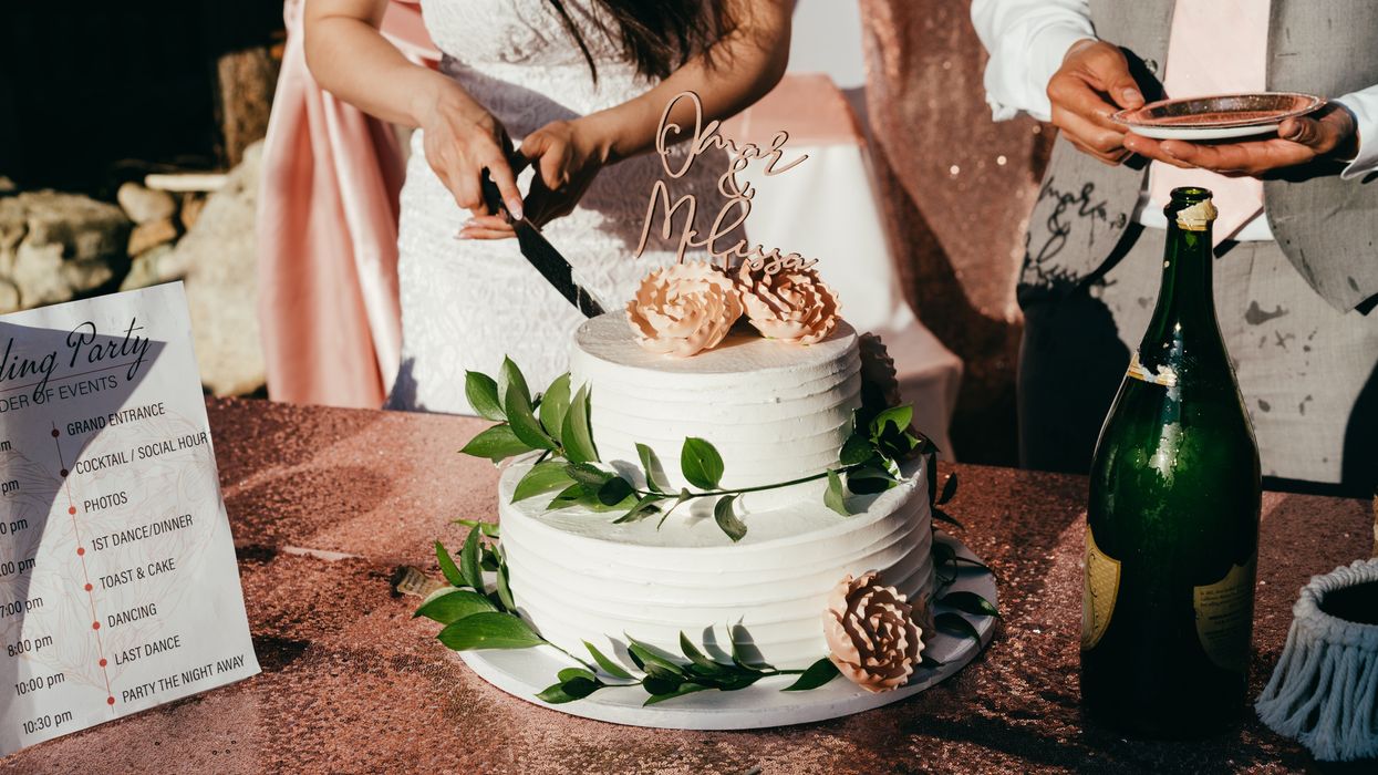 Bride slicing wedding cake