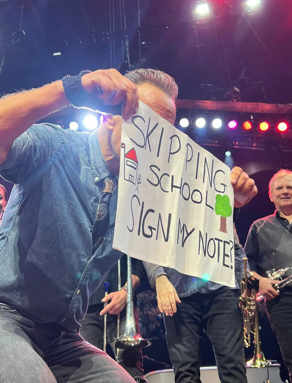 Bruce Springsteen holding the girl's sign