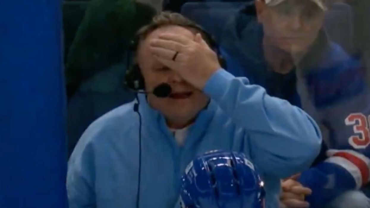 Buffalo Sabres commentator Rob Ray covering his eye after being hit by hockey puck