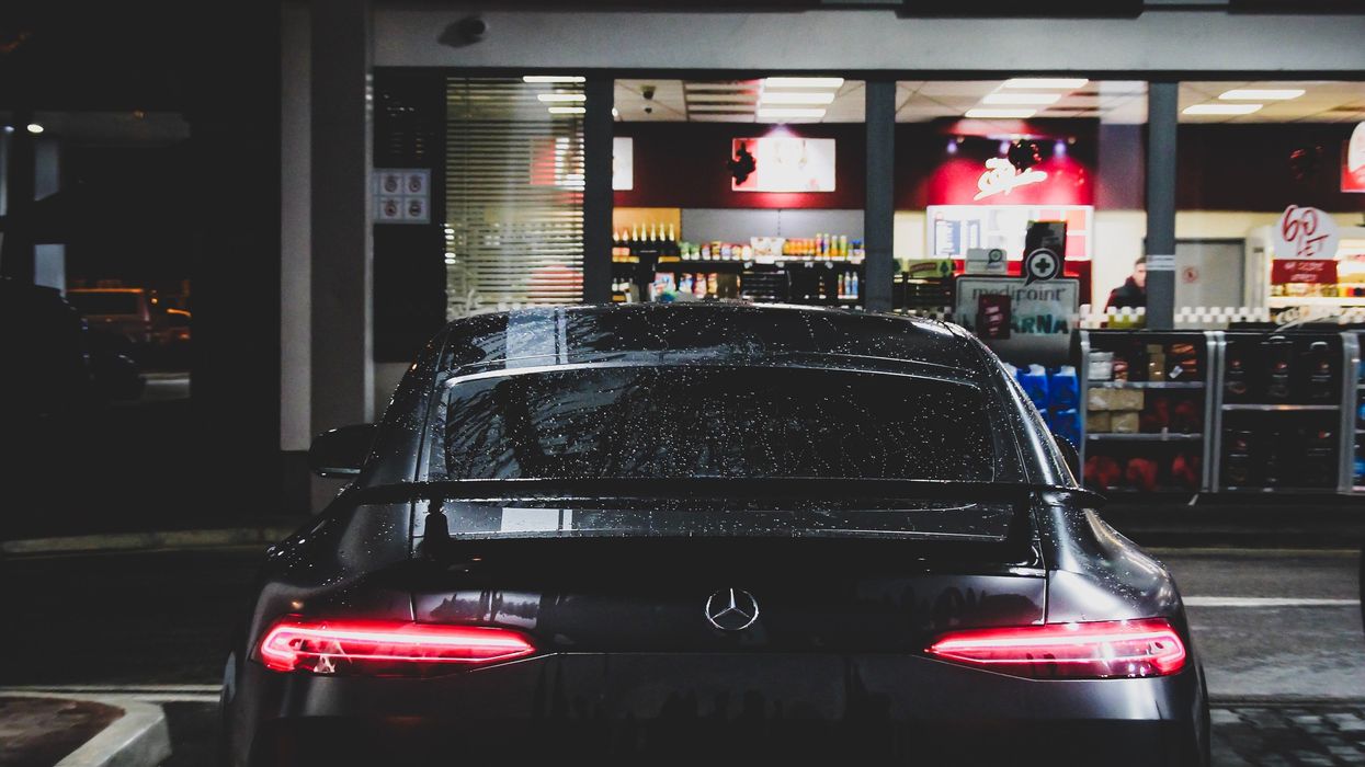 Car parked in front of a convenience store