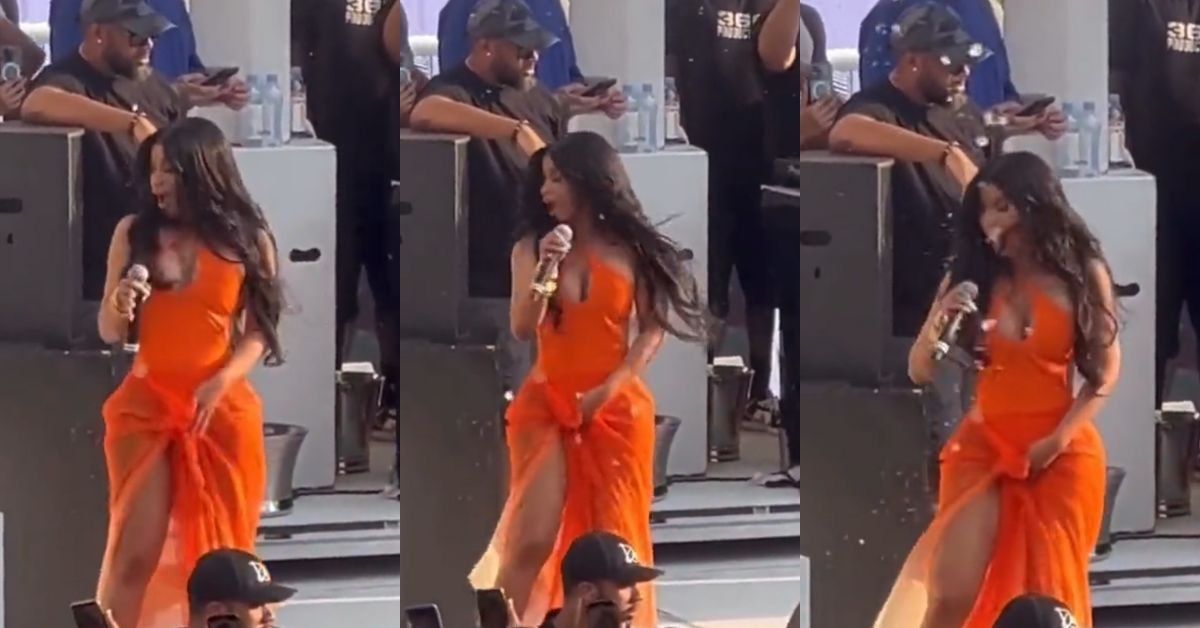 Cardi B getting splashed with a beverage at a concert