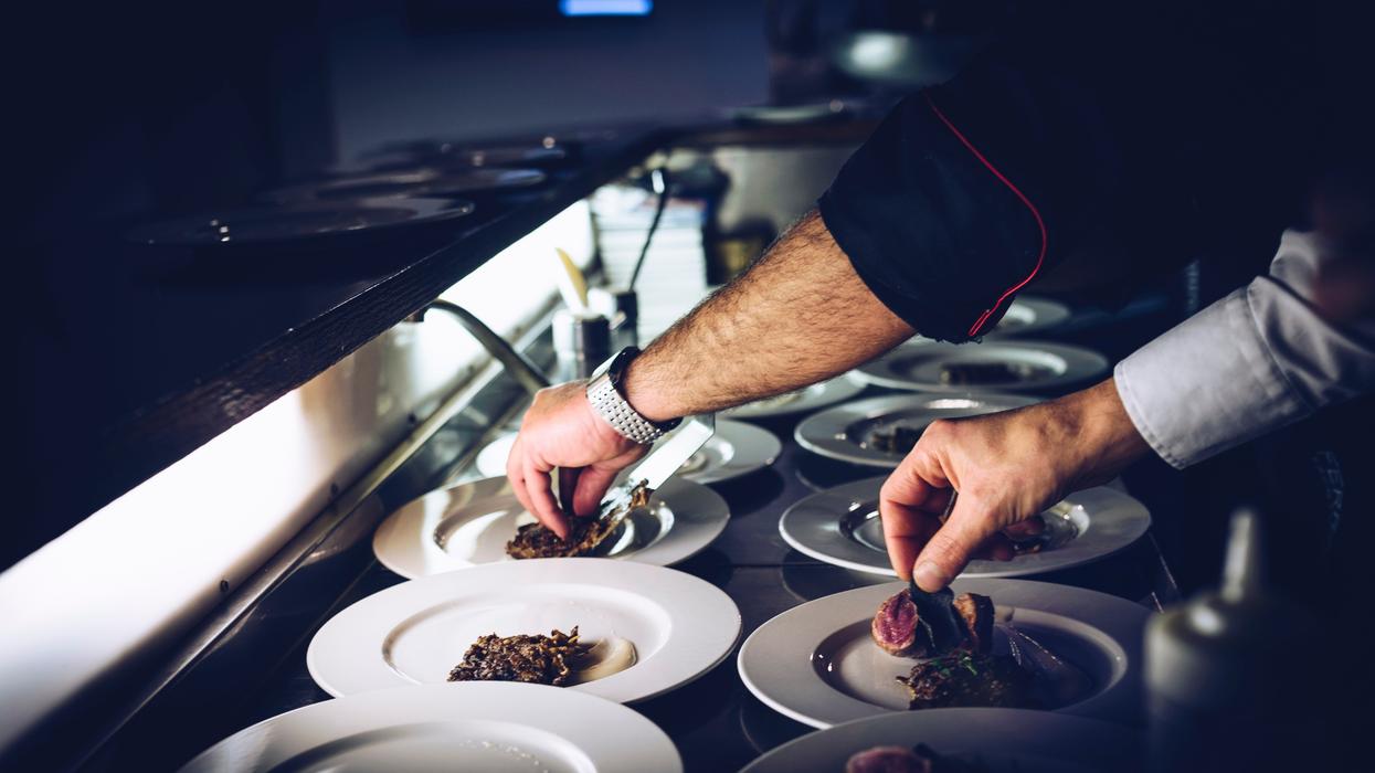 Chef preparing gourmet dishes in high-end restaurant