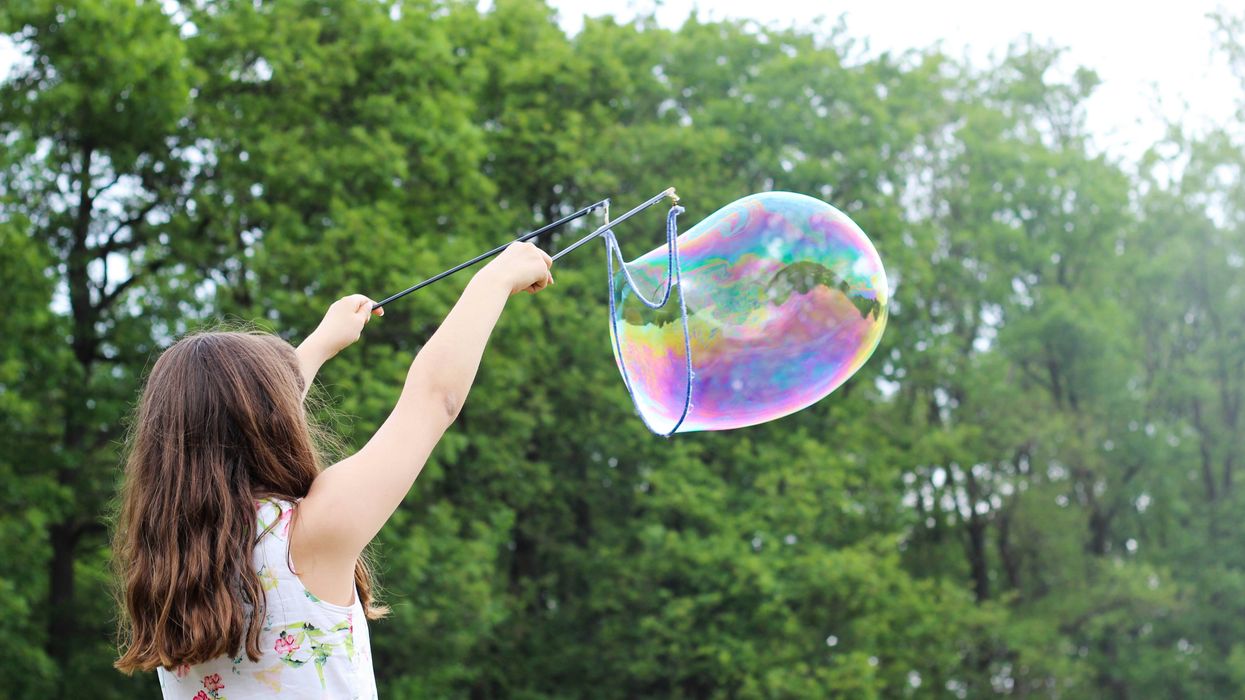 Child playing with bubbles