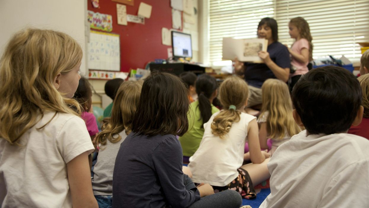 children sitting on floor in classroom