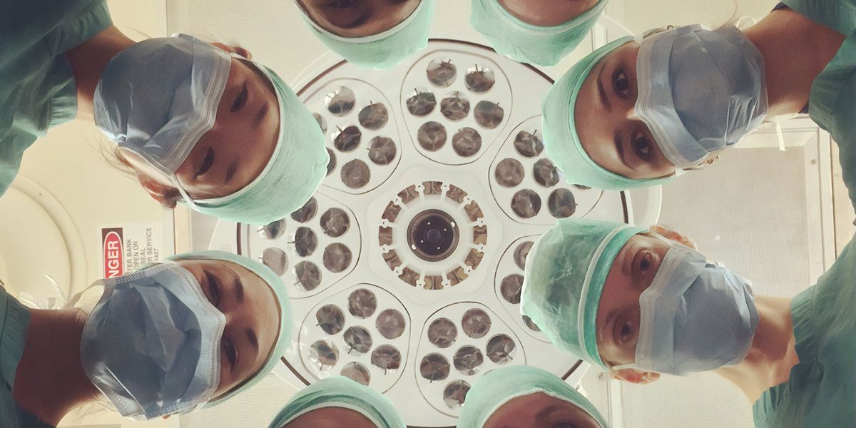 Circle of doctors faces looking into a camera