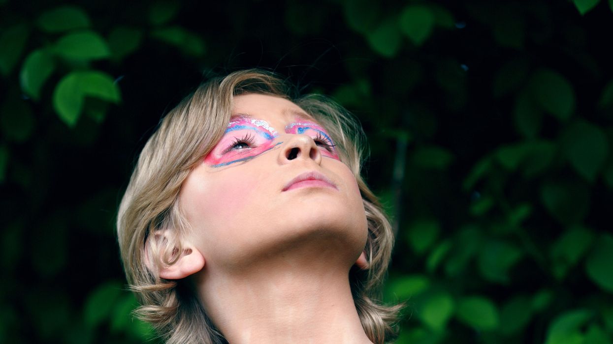 close-up of child's blue shirt with "Love who you are" written on it