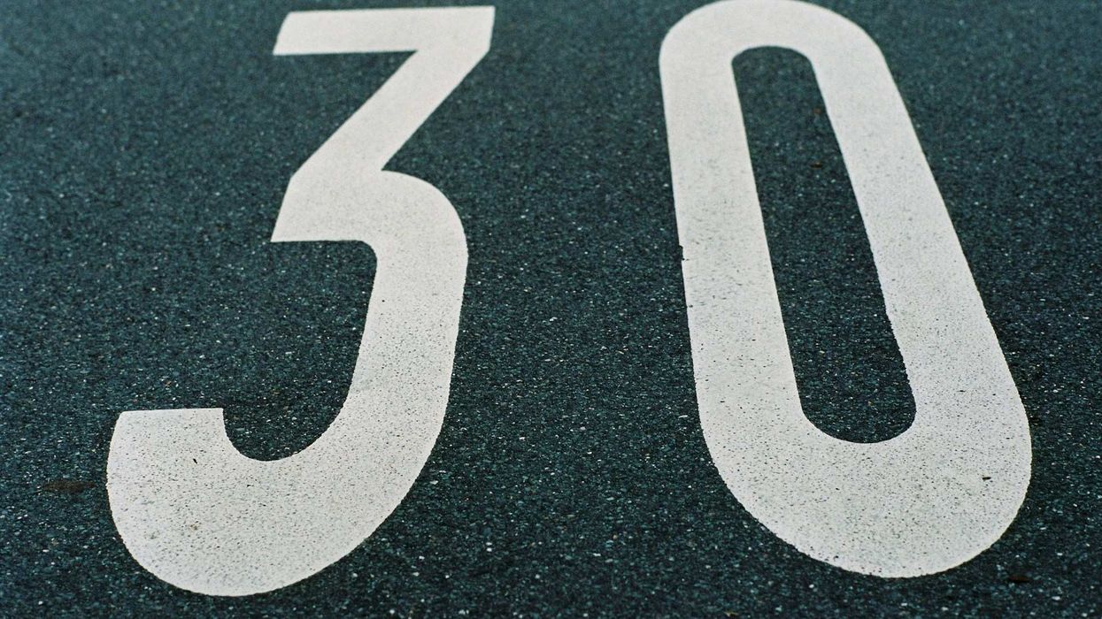 Close-up shot of the number 30 painted on asphalt.
