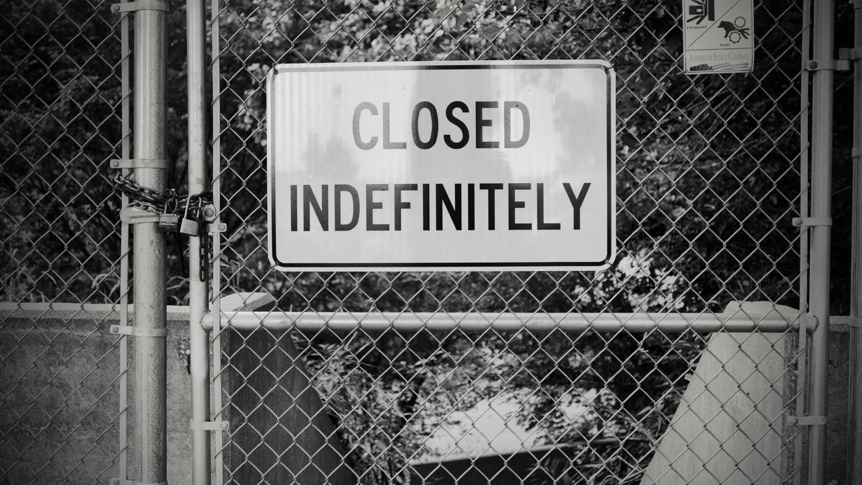 closed indefinitely sign on a chain link fence