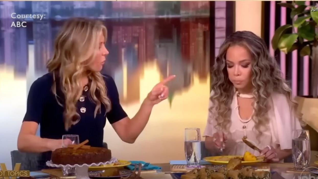 Co-Host of The View, Sunny Hostin eats walnuts from former co-host Debbie Matenopoulos' Greek Orzo salad.