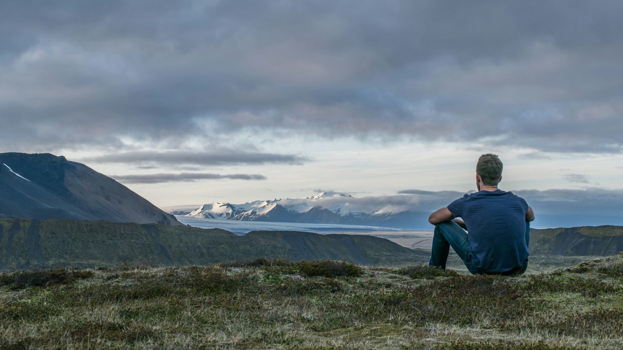 Contemplative man out in nature looking at mountain views