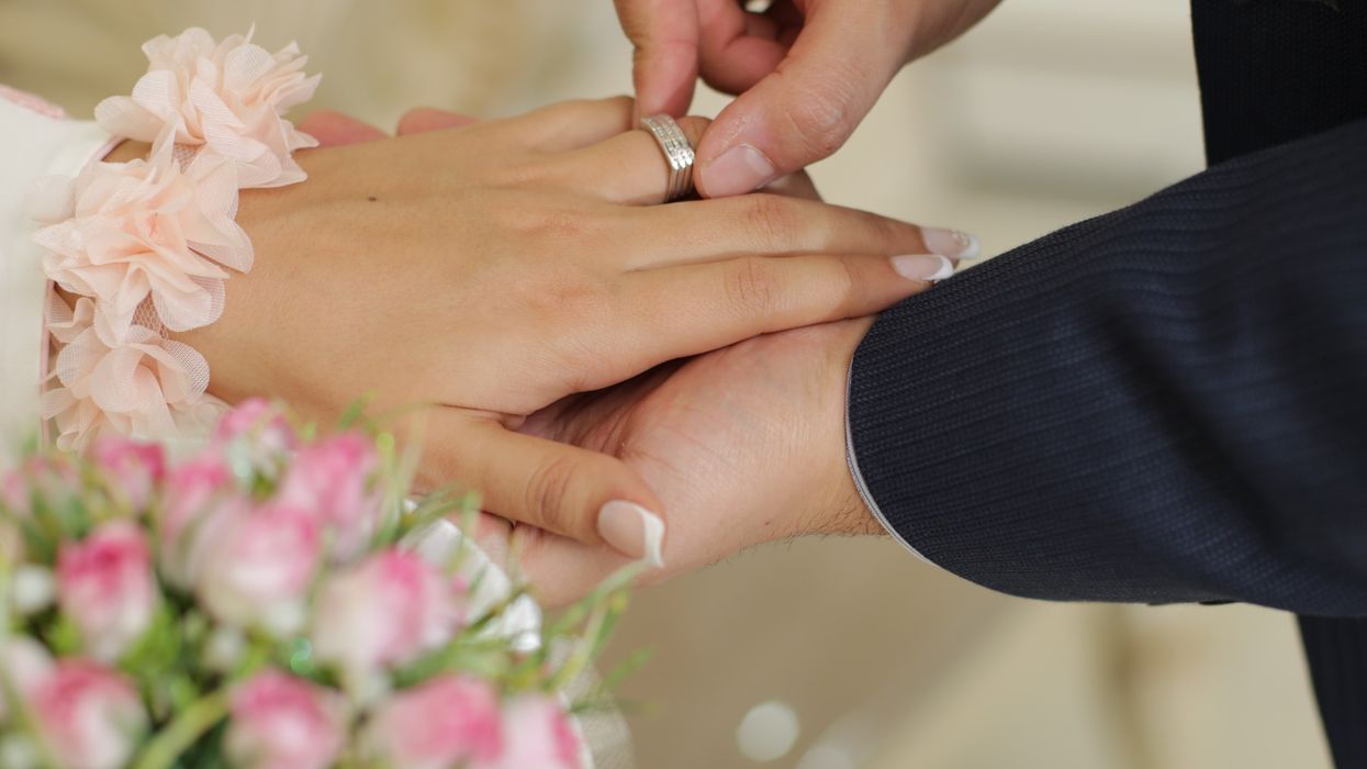 Couple exchanging rings on wedding day