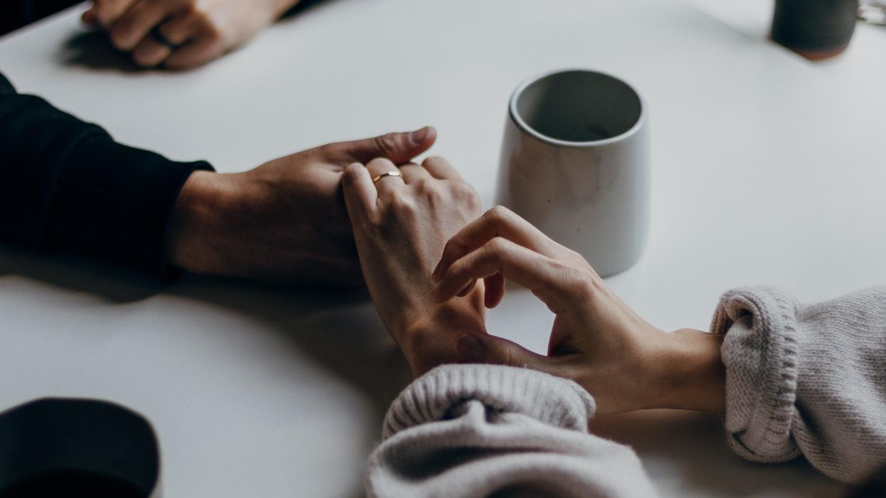 Couple holding hands at a coffee shop