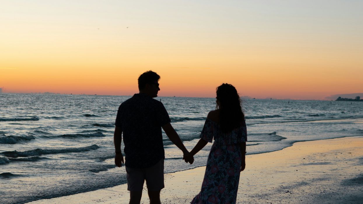 Couple holding hands on beach