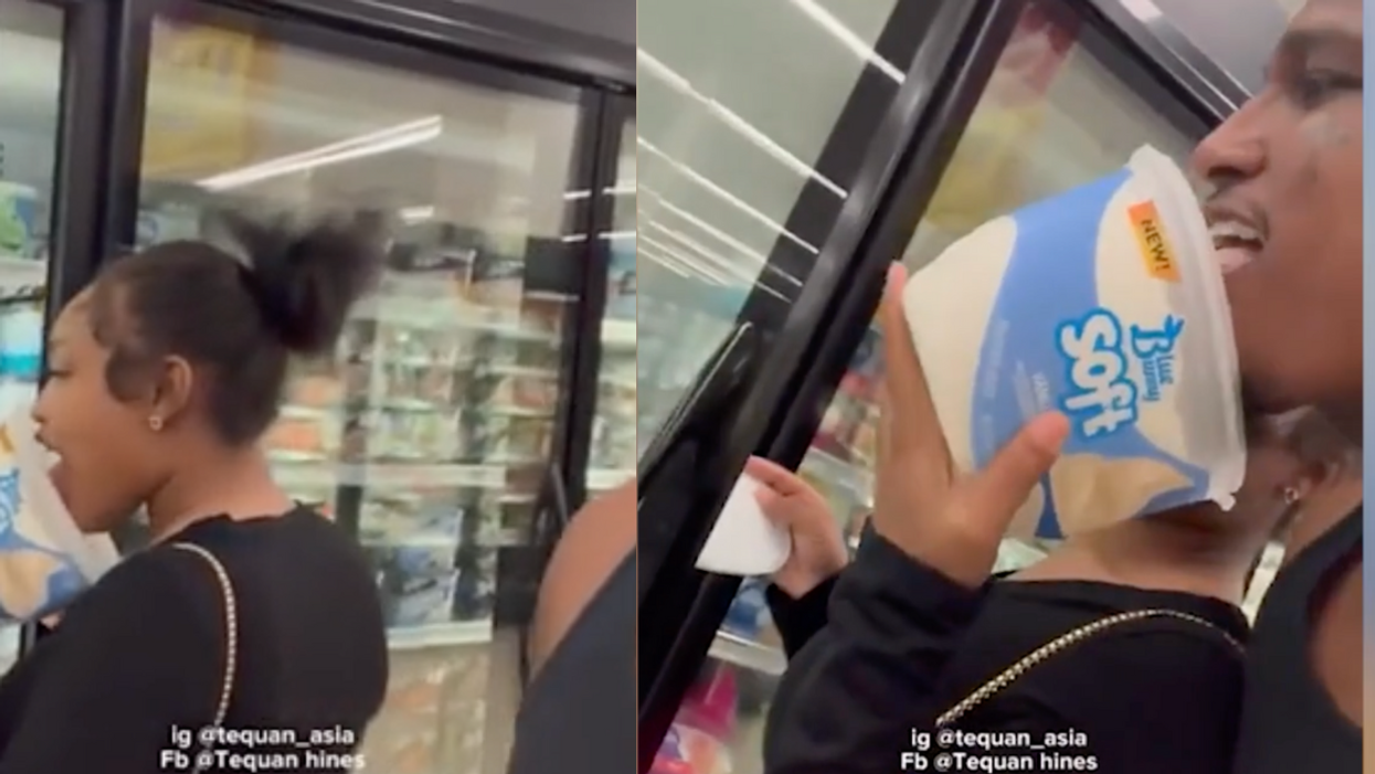 Couple licking inside of ice cream container in supermarket