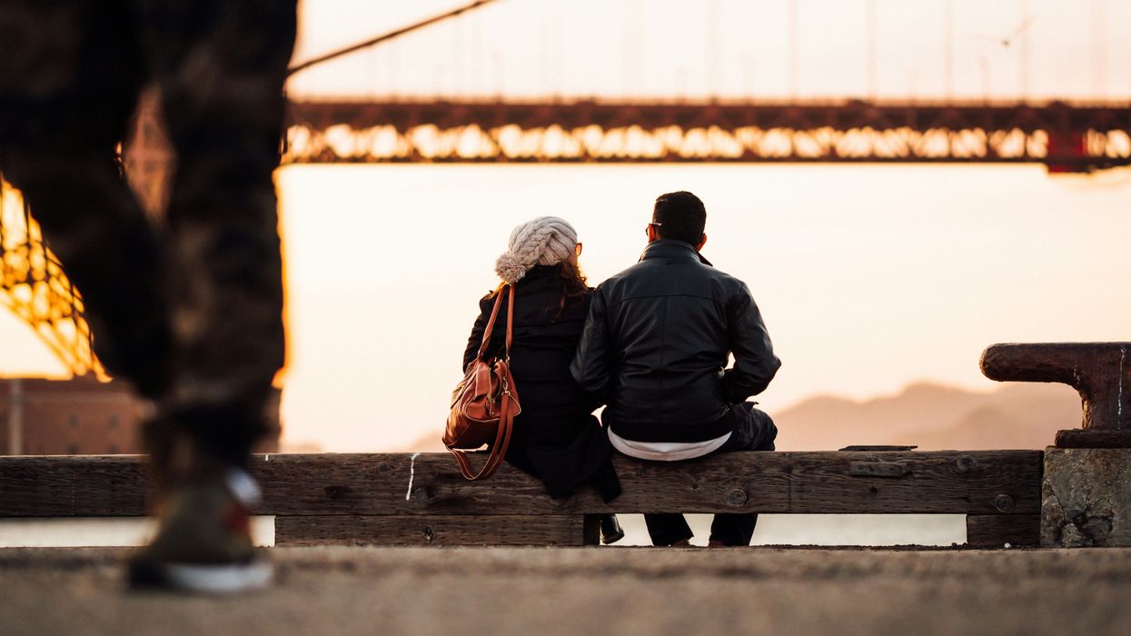 couple sitting together looking at Golden Gate Bridge
