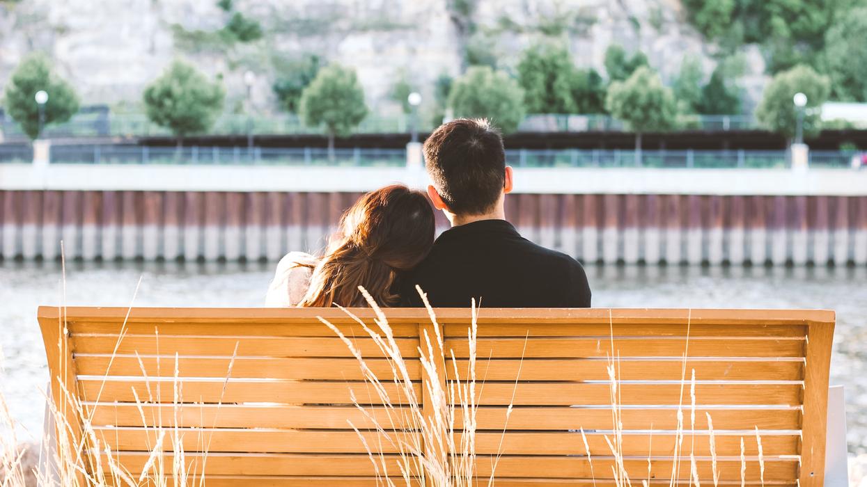 Couple sitting together on bench