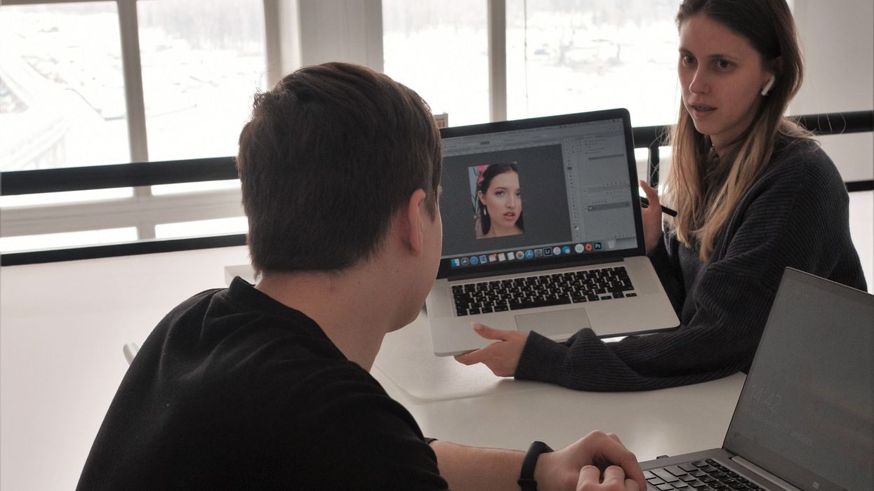 coworkers looking at a laptop