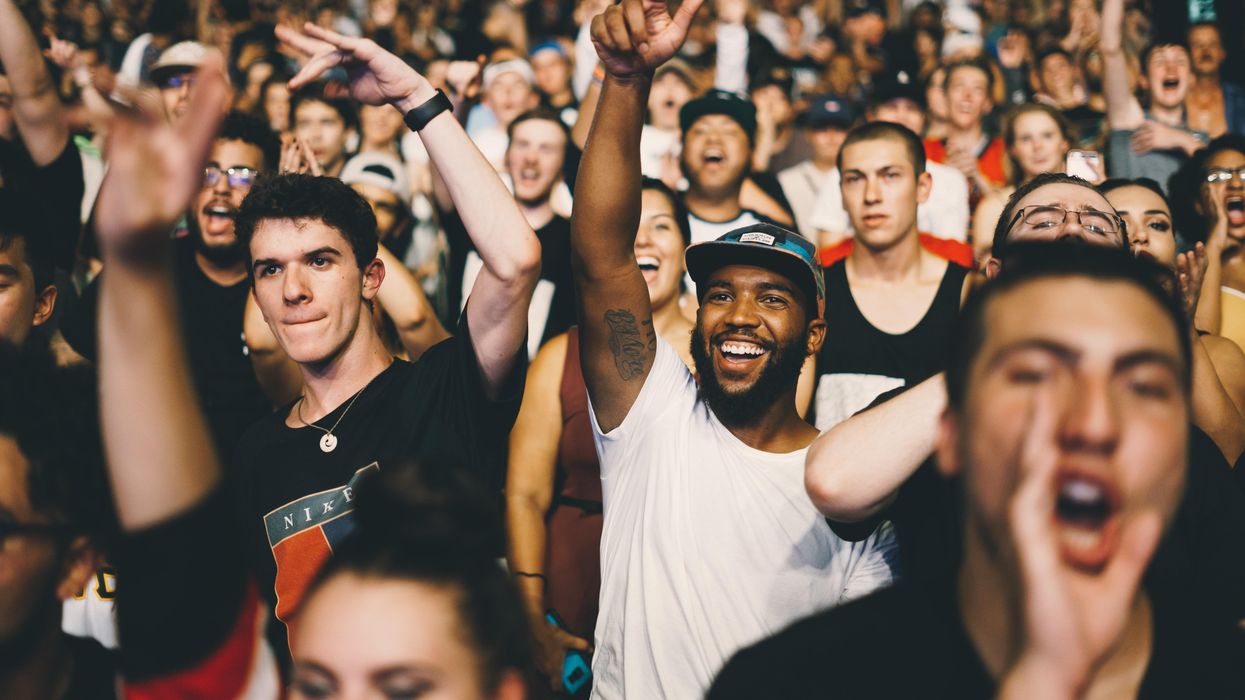 crowd of young people standing and cheering