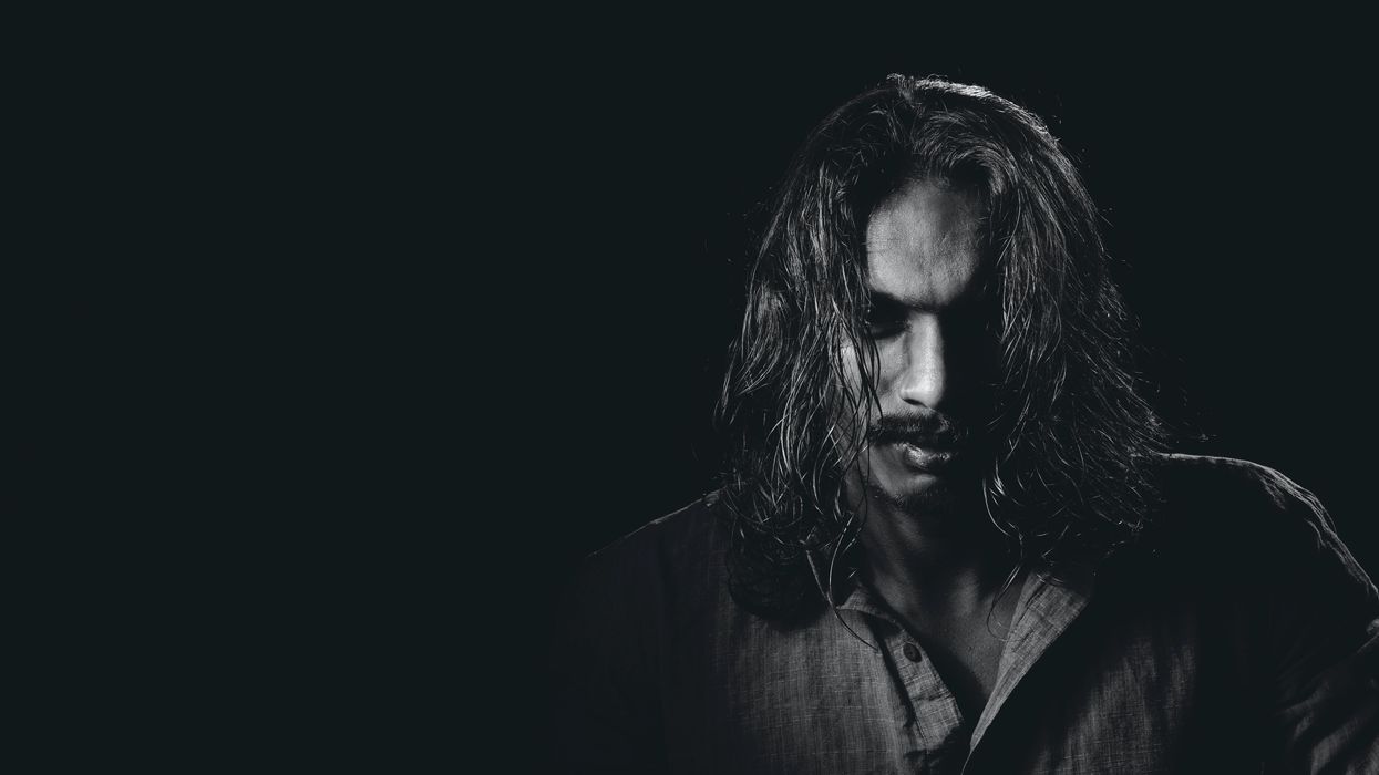 Dark black and white photo of man