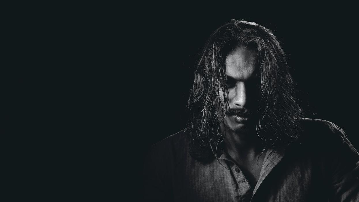 Dark black and white photo of man