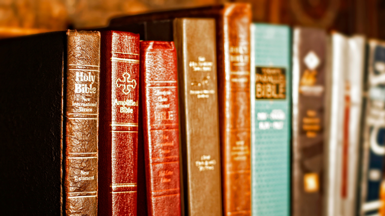 Different Bibles on a bookshelf