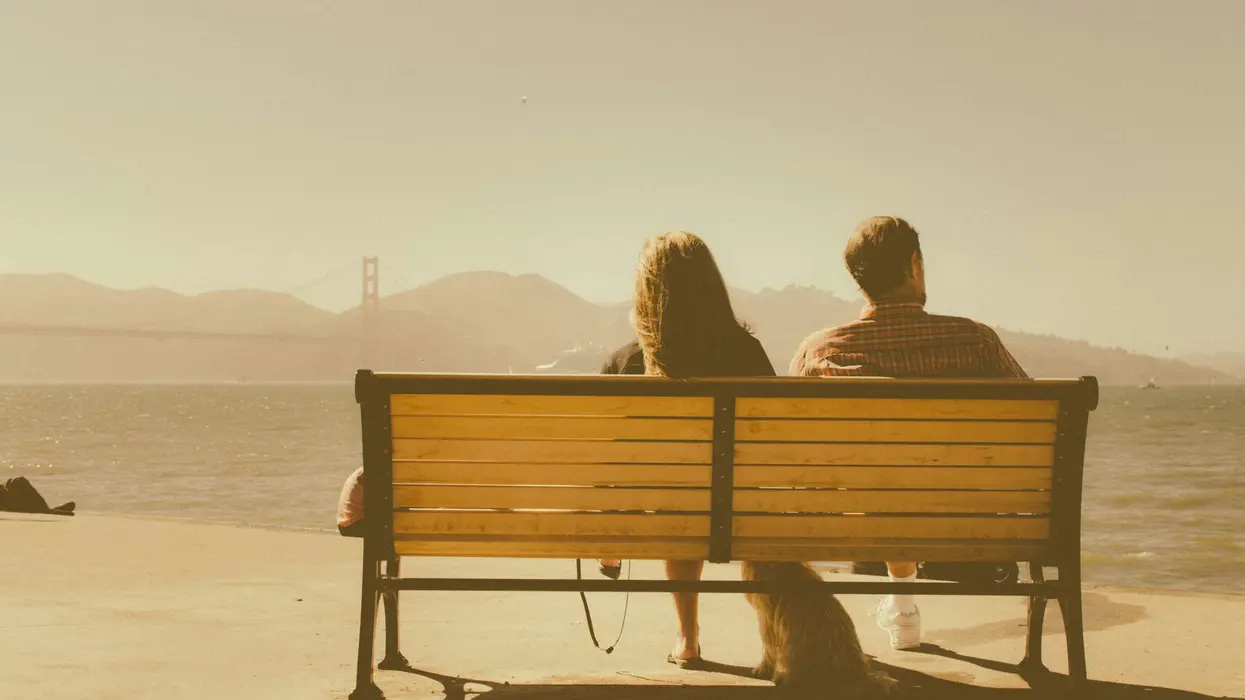 Distant couple sitting on bench