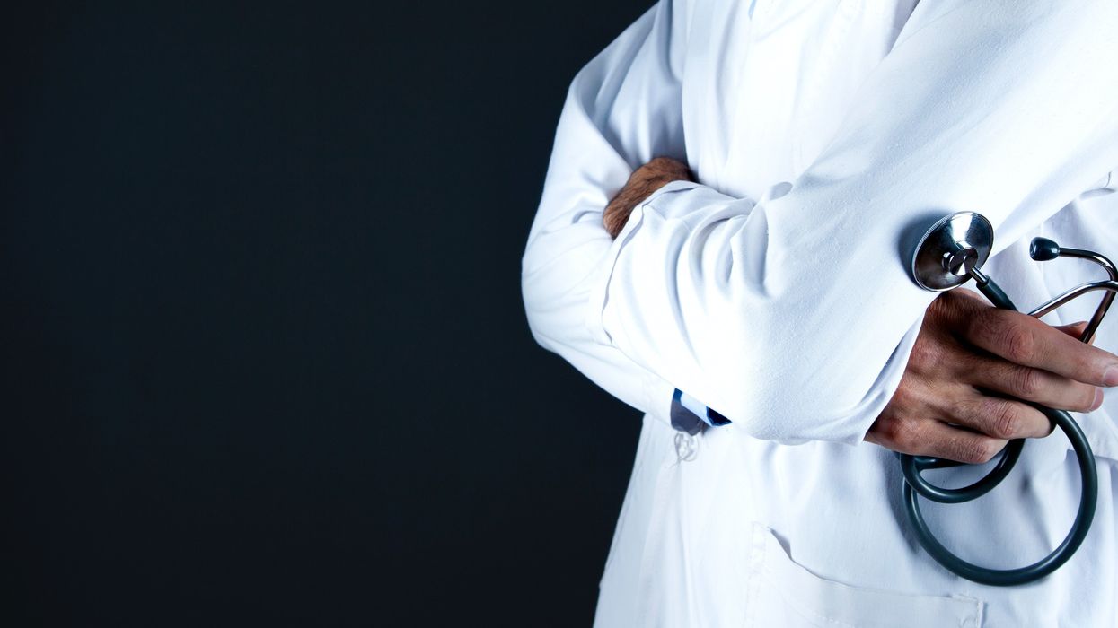 Doctor with arms crossed holding stethoscope