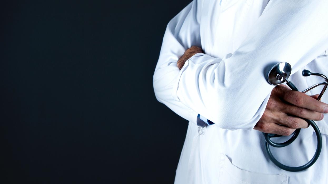 Doctor with arms crossed holding stethoscope