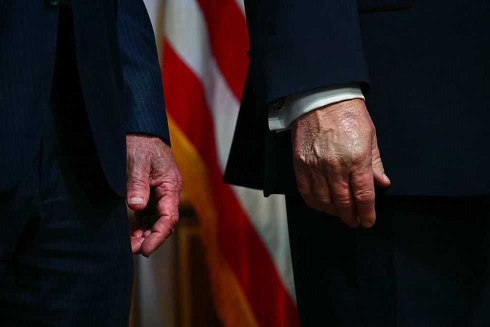 Donald Trump and Robert F. Kennedy Jr.'s respective hands