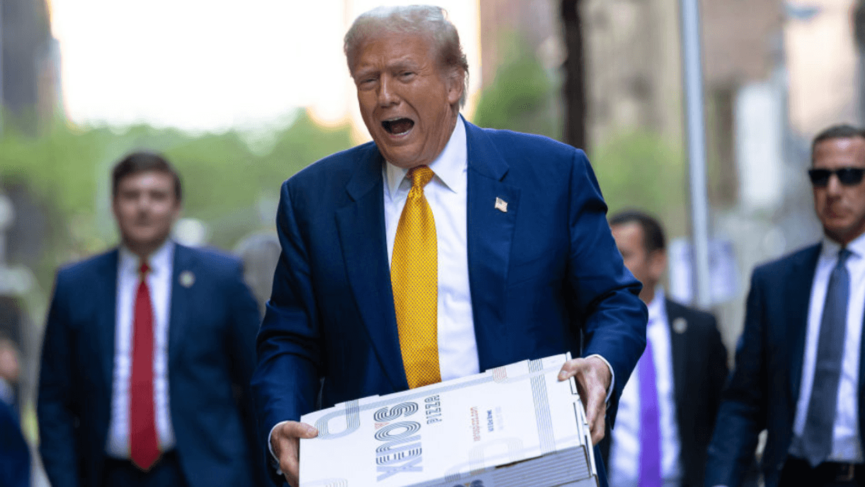 Donald Trump carrying a pizza box