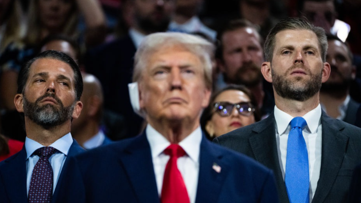 Donald Trump flanked by Donald Trump Jr. and Eric Trump
