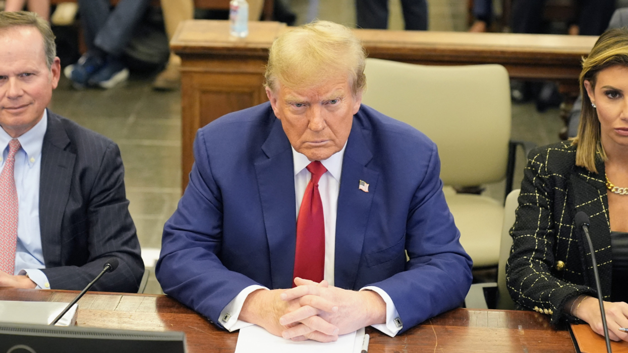 Donald Trump flanked by his lawyers, Christopher Kise and Alina Habba
