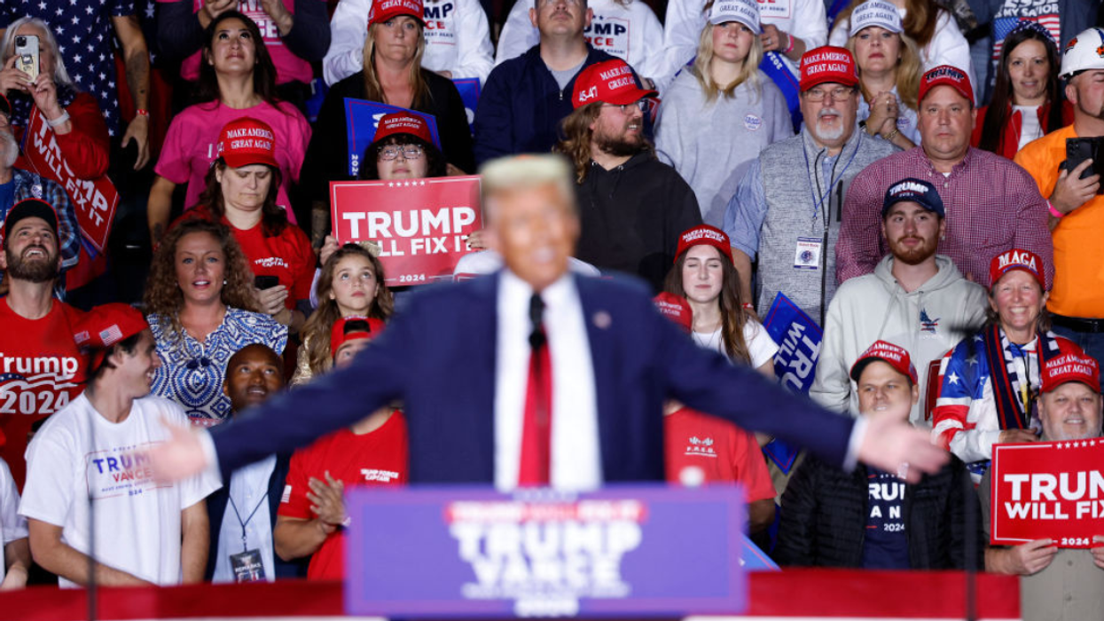 Donald Trump flanked by supporters