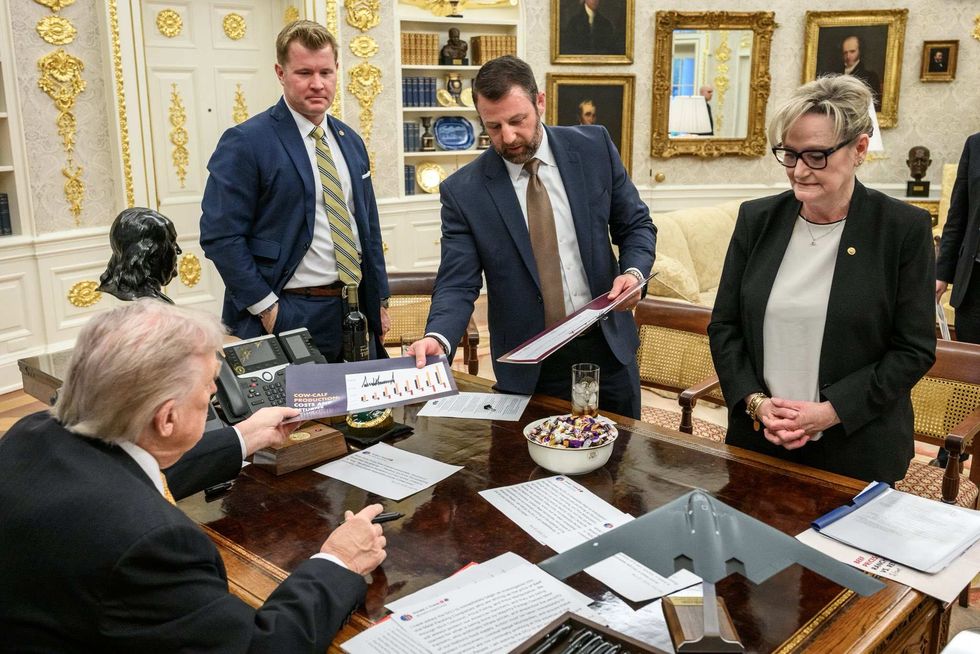 Donald Trump has his own tweets across his desk in the Oval Office